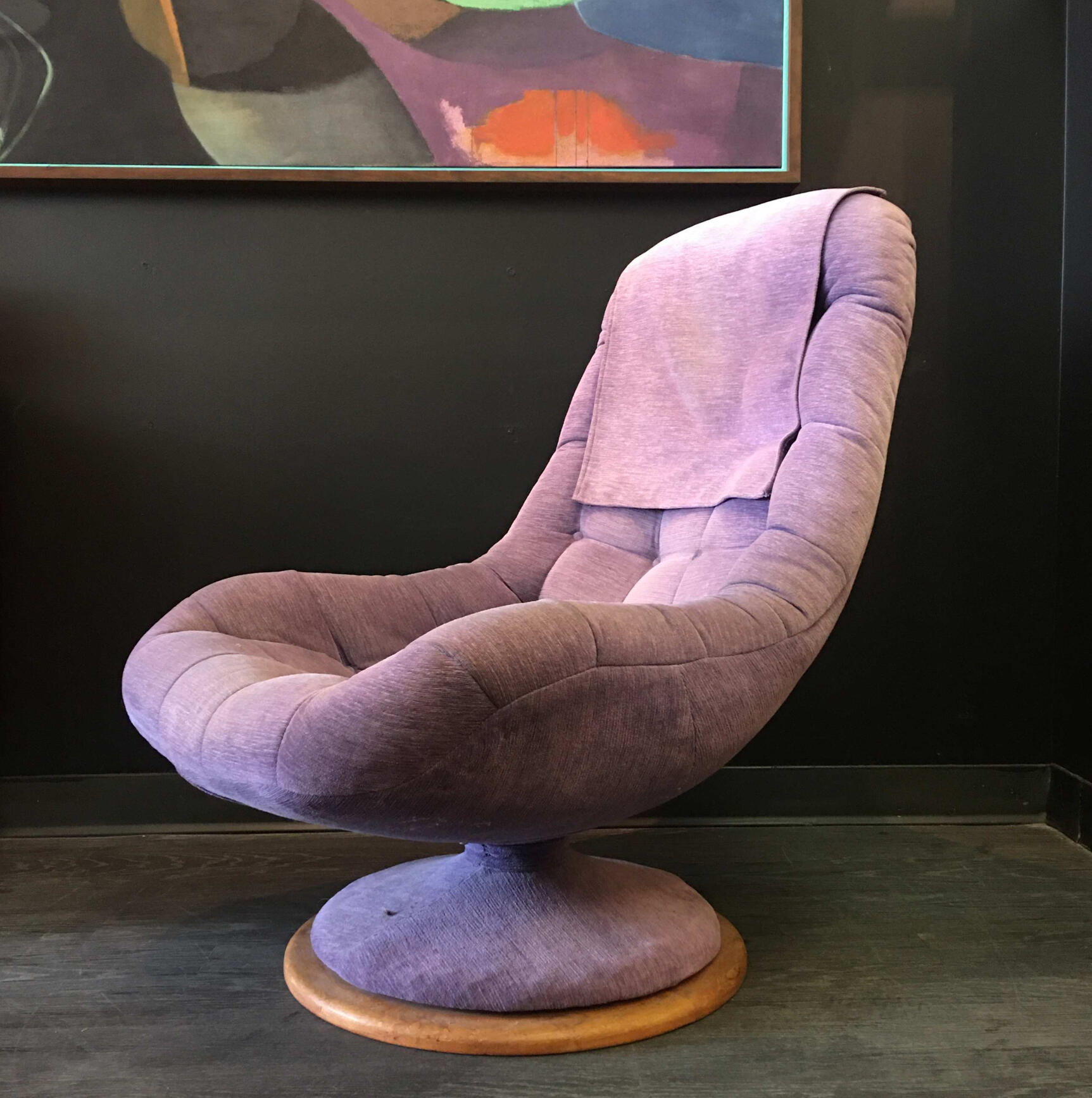 vintage purple swivel chair with abstract art in the background